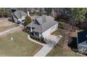 An aerial view of a well-manicured property with a spacious driveway and lush landscaping at 704 Kenway Loop, Mooresville, NC 28117