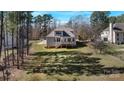 Spacious backyard with mature trees and a wooden deck, perfect for outdoor entertaining and relaxation at 704 Kenway Loop, Mooresville, NC 28117