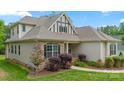 Well-maintained home featuring stone accents and manicured landscaping at 704 Kenway Loop, Mooresville, NC 28117
