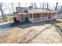 Brick ranch house with covered porch and mature trees, offering curb appeal at 1008 E Sandy Ridge Rd, Monroe, NC 28112