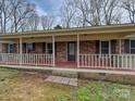 Inviting front porch with brick accents and a cozy spot for relaxing in the shade at 1008 E Sandy Ridge Rd, Monroe, NC 28112