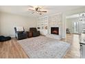 Inviting living room with a brick fireplace and built-in shelving, perfect for cozy evenings at 1008 E Sandy Ridge Rd, Monroe, NC 28112