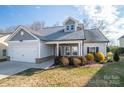 Two-story house with gray siding, white garage door, and landscaping at 102 Lake George Dr, Shelby, NC 28152