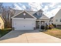 Two-story house with gray siding, white garage door, and landscaping at 102 Lake George Dr, Shelby, NC 28152