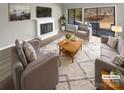 Virtually staged living room features fireplace and sliding doors at 11212 Carmel Chace Dr # 101, Charlotte, NC 28226