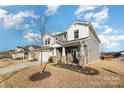 Two-story house with gray siding, stone accents, and a three-car garage at 12613 Stoneybrook Station Pkwy, Huntersville, NC 28078