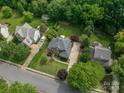 Aerial view of the home with mature landscaping, a large driveway, and surrounding neighborhood at 133 Castaway Trl, Mooresville, NC 28117
