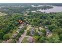 Aerial view of a residential neighborhood with tree-lined streets and lake in the background at 133 Castaway Trl, Mooresville, NC 28117