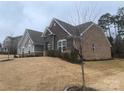 Brick house with stone accents, situated on a grassy lot with mature trees at 1336 Stonecrest Blvd, Fort Mill, SC 29708