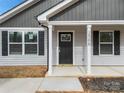 Charming front entrance with gray door and white columns at 1506 Collinston Dr, Gastonia, NC 28052