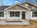 Front view of a charming house with a dark brown door and gray accents at 1508 Collinston Dr, Gastonia, NC 28052