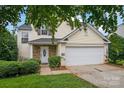 Two-story house with a two-car garage and landscaping at 2111 Bennett Woods Ct, Charlotte, NC 28216