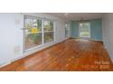 Spacious living room with hardwood floors and large windows at 218 Kingsway Cir, Charlotte, NC 28214