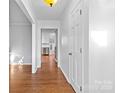 Bright entryway with hardwood floors leading to the kitchen and other rooms at 2512 Heathershire Ln, Matthews, NC 28105