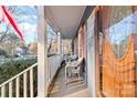 Inviting front porch with two wicker chairs, offering a relaxing space at 2512 Heathershire Ln, Matthews, NC 28105