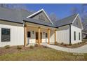 Craftsman style home with white exterior, gray accents, and a wooden front porch at 2712 Yellow Bell Way, Monroe, NC 28112