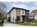 Modern two-story home with driveway, attached garage, and landscaped yard at 308 Dover Ave, Charlotte, NC 28209