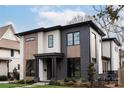 Modern two-story home with gray and white siding, wood accents, and a landscaped lawn at 308 Dover Ave, Charlotte, NC 28209