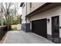 Attached garage with concrete driveway and a modern design at 308 Dover Ave, Charlotte, NC 28209