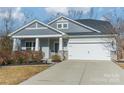 Gray exterior home with white garage door and landscaping at 3101 Elmwood Dr, Monroe, NC 28110