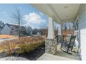 Relaxing front porch with rocking chairs, stone pillars, and neighborhood view at 3101 Elmwood Dr, Monroe, NC 28110