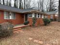 Brick ranch home with front porch and landscaping at 3103 Minnesota Rd, Charlotte, NC 28208