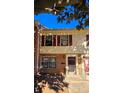 Two-story brick townhouse, featuring red shutters and a walkway at 4663 Old Lantern Way, Charlotte, NC 28212