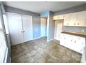 White kitchen cabinets and appliances, tile floor, and ample storage at 4663 Old Lantern Way, Charlotte, NC 28212