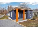 Newly renovated home with a blue exterior and a front porch at 503 Birch St, Lowell, NC 28098