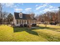 Beautiful angle view of two-story home with dormer windows, shutters, landscaping and lawn at 670 Sylvan Sw St, Concord, NC 28025