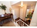 Inviting entryway with hardwood floors, piano, and coat closet at 6710 Elm Forest Dr, Charlotte, NC 28212