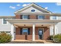 Two-story brick front elevation of home with covered porch at 7822 Meridale Forest Dr, Charlotte, NC 28269