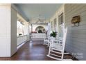 Spacious front porch with rocking chairs and wooden flooring at 808 E Worthington Ave, Charlotte, NC 28203