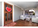 Inviting front porch with wooden flooring and wicker furniture at 808 E Worthington Ave, Charlotte, NC 28203