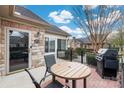 Private patio with table, chairs, and grill; perfect for outdoor dining at 874 Ledgestone Ct, Tega Cay, SC 29708