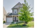 Two-story house with gray siding, stone accents, and a tree in the front yard at 970 Bunker Trce, Rock Hill, SC 29730