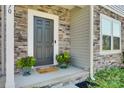 Modern dark gray front door flanked by stonework and greenery at 970 Bunker Trce, Rock Hill, SC 29730