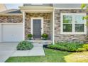 Inviting front entrance with stone facade, dark door, and potted plants at 970 Bunker Trce, Rock Hill, SC 29730