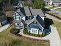 Stunning two-story house, gray siding, stone accents, and a large yard at 100 S Centurion Ln, Mount Holly, NC 28120