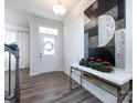 Bright foyer with hardwood floors, a decorative console table, and a staircase at 11021 Ogden Ln, Charlotte, NC 28278