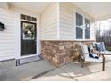 Inviting front porch with stone accents and comfortable seating area at 11021 Ogden Ln, Charlotte, NC 28278