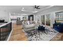 Spacious living room with open floor plan, modern furnishings, and access to an outdoor deck at 113 Brentwood Dr, Maiden, NC 28650