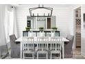 Bright dining room with shiplap walls and stylish chandelier at 127 Fordham Ct # 02, Fort Mill, SC 29715