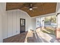 Covered porch with tile flooring and ceiling fan at 1325 Bostwood Ln, Concord, NC 28025