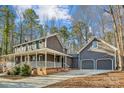 Two-story house with wraparound porch, attached garage, and driveway at 14264 Maple Hollow Ln, Mint Hill, NC 28227