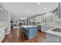 Open concept kitchen with island and hardwood floors at 15903 Glen Miro Dr, Huntersville, NC 28078