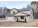 Two-story brick home with a two-car garage and landscaping at 1938 Grace Ln, Charlotte, NC 28262