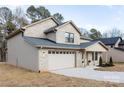 Two-story brick home with a two-car garage and landscaping at 1938 Grace Ln, Charlotte, NC 28262