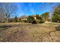 Side view of the house highlighting the backyard and landscaping at 194 Bynum Rd, Lincolnton, NC 28092