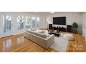 Bright living room featuring modern sofa, large windows and beautiful wood flooring at 2151 Belle Vernon Ave, Charlotte, NC 28210